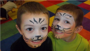 Boys with faces painted like tigers